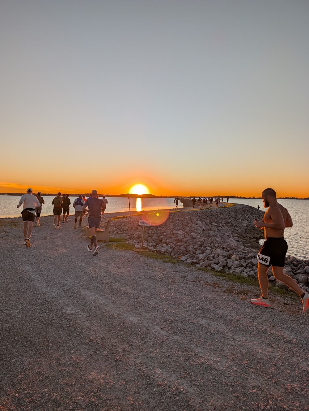 Runners circling Findlay Reservoir at sunset during the 2026 Flag City Backyard Ultra